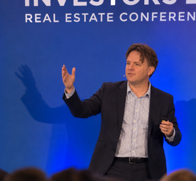 Travis McAllister, Chief Executive Officer of 1st Finance, speaking at a real estate conference